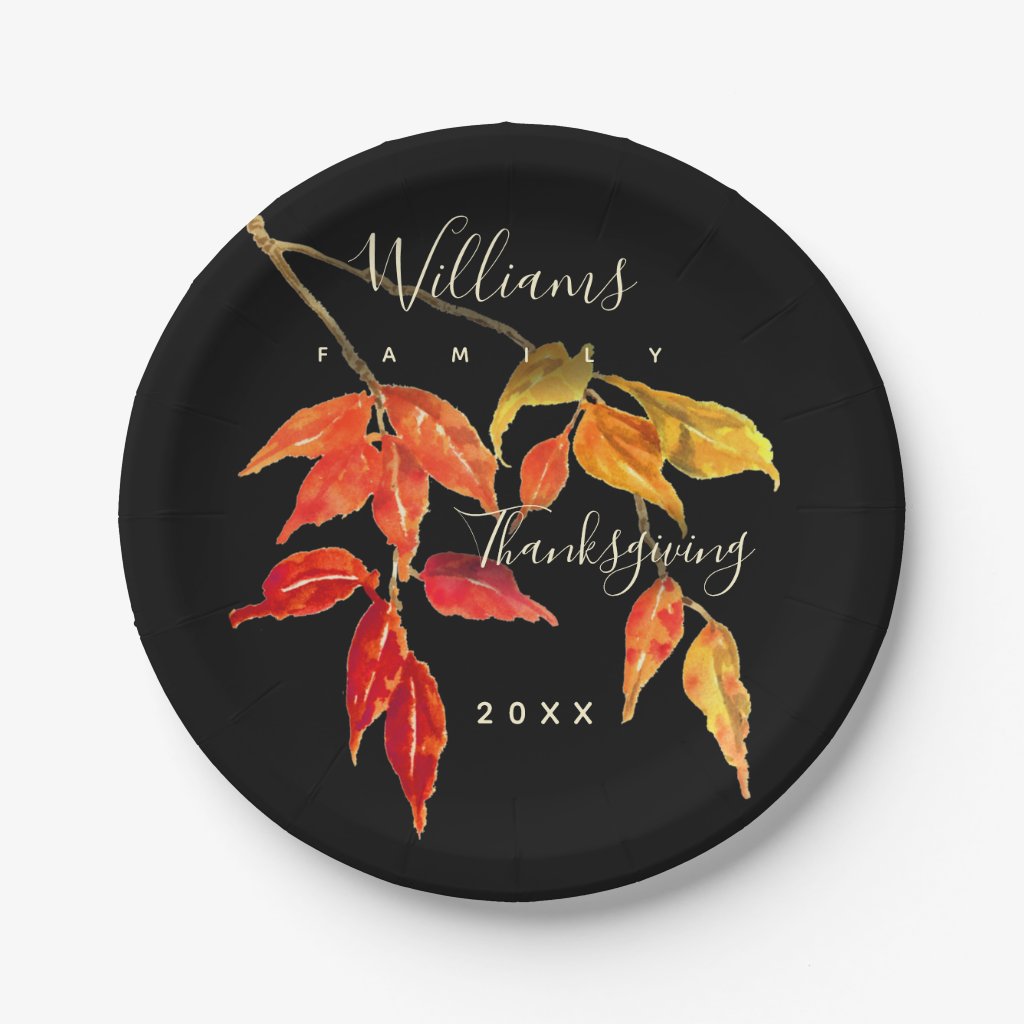 Paper plate with watercolor design of autumn leaves in red, orange and yellow on a black background 