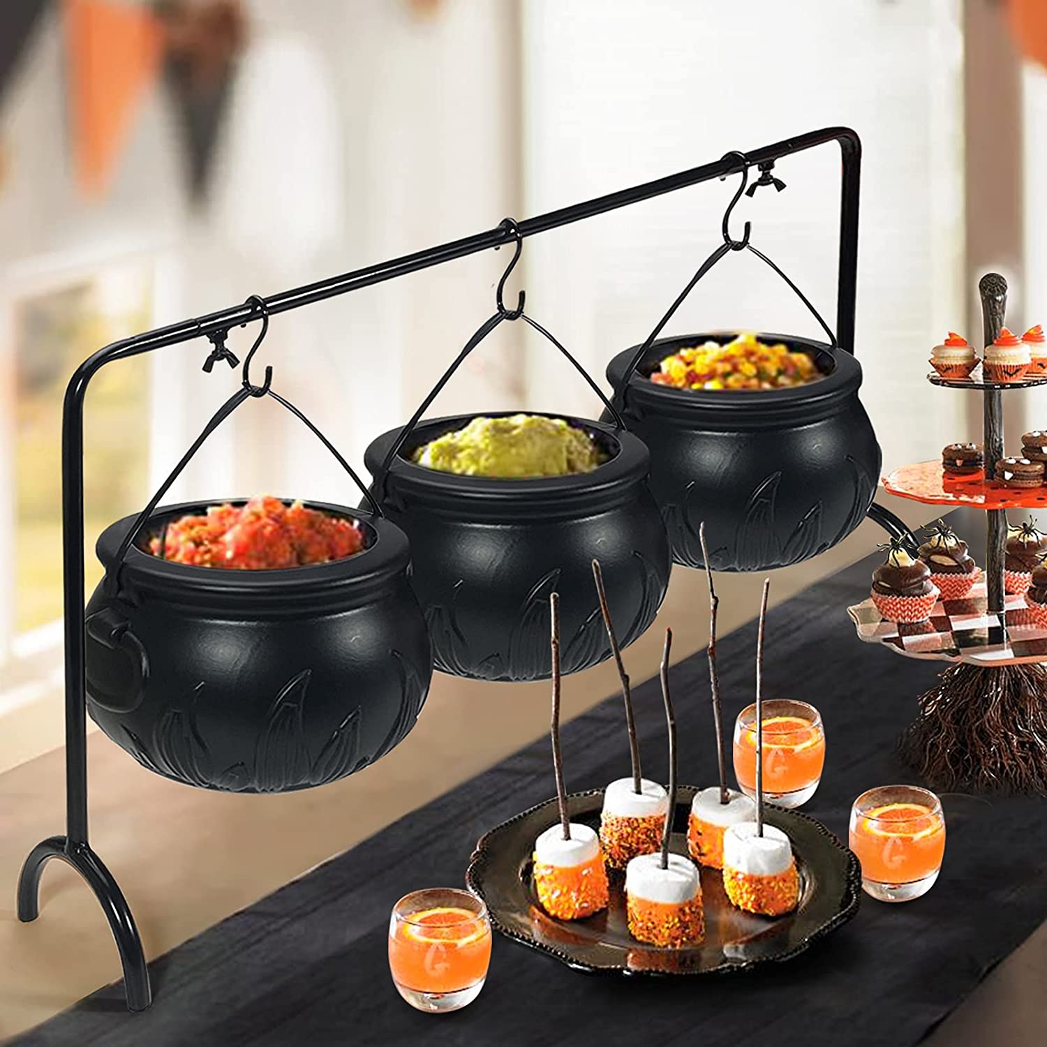 trio of Witches cauldrons have shiny black finish, metal handle equipped.